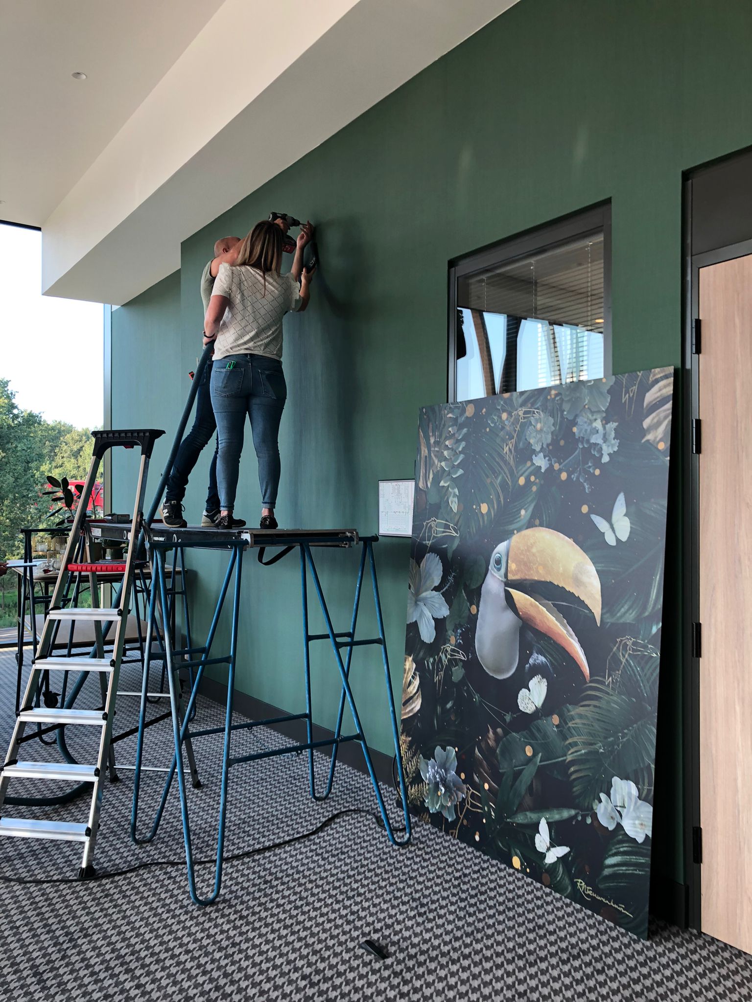 Preparing the wall for the vertical Toekan artwork