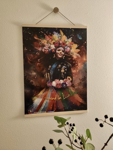 Carnival poster displayed on a wall with wooden hanging rails