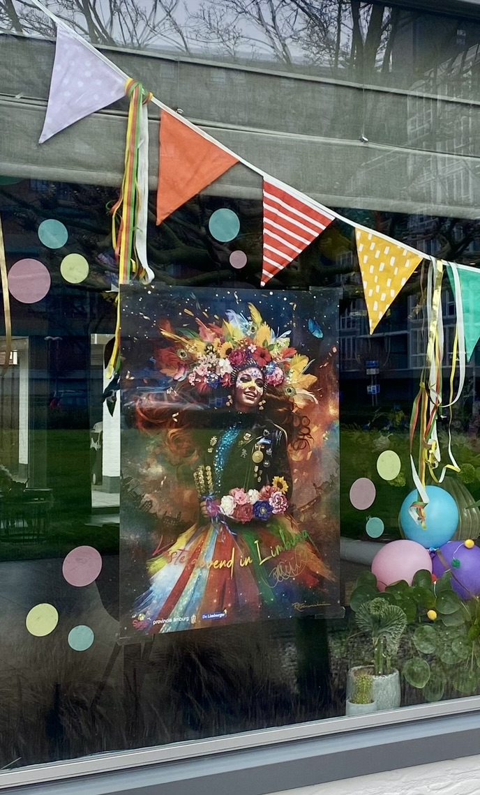 Carnival poster in a window decorated with bunting